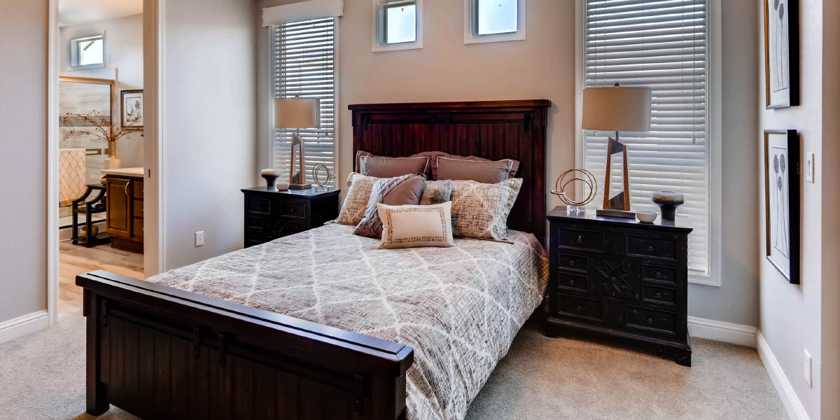 Slide Three Model Home Interior Bedroom Tastefully Decorated in Neutrals